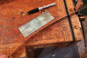 Marking a curve on a scraper. 